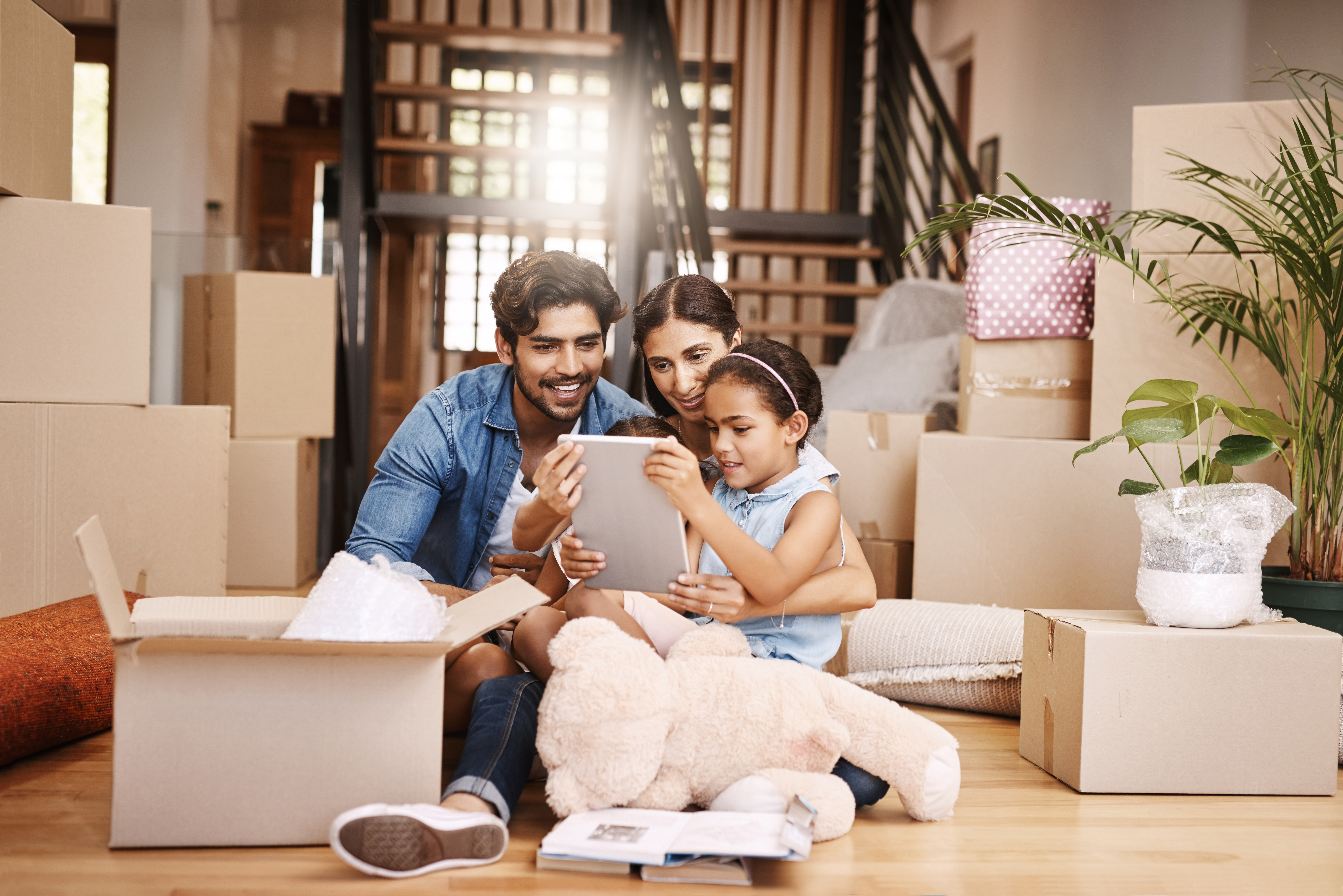 Moving to New Zealand from India: a complete 2026 guide family moving day watching tablet together indoors 2026 03 25 04 03 14 utc