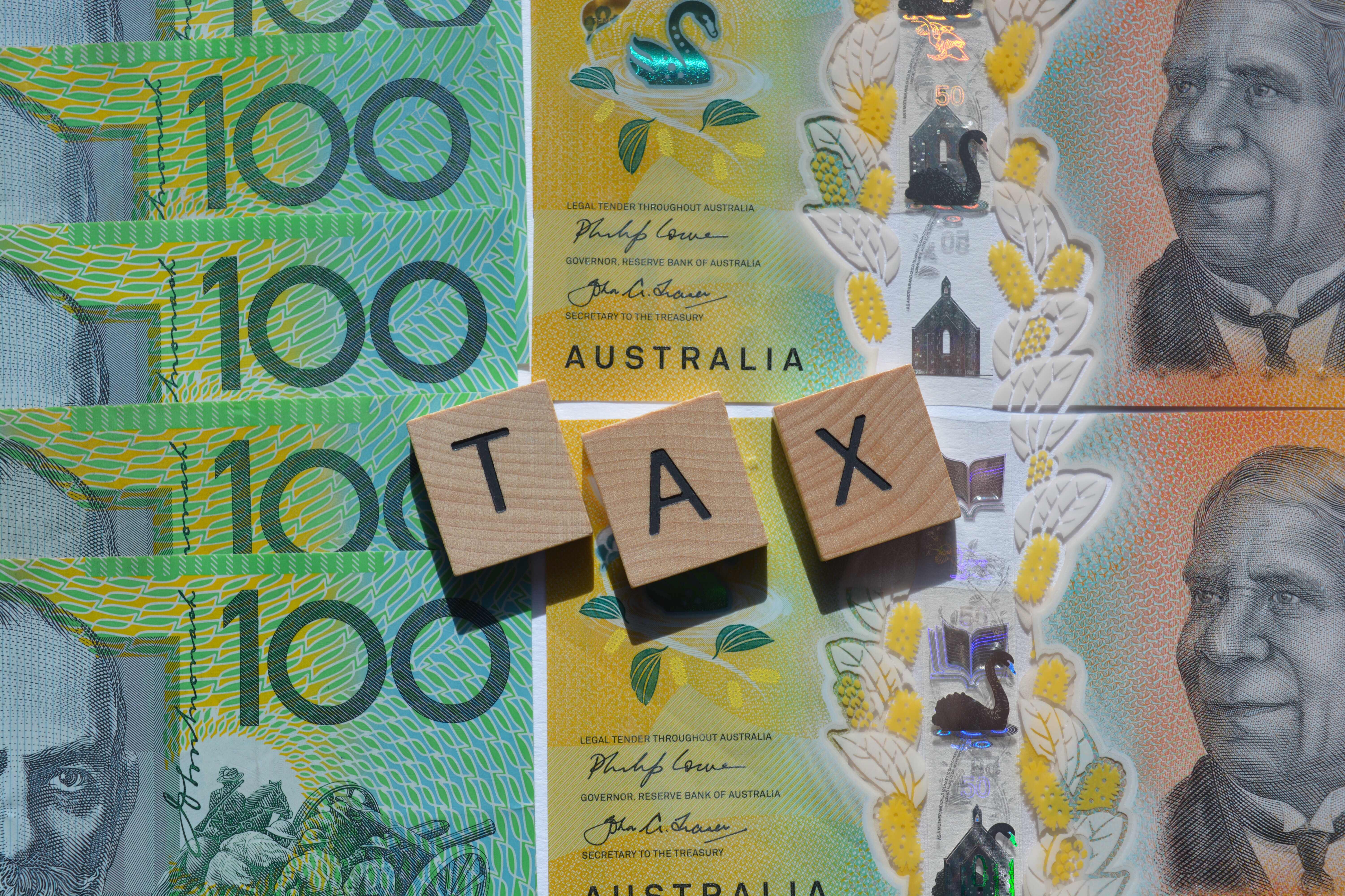 tax word in wood letters on top of australian hig 2026 03 19 23 16 12 utc