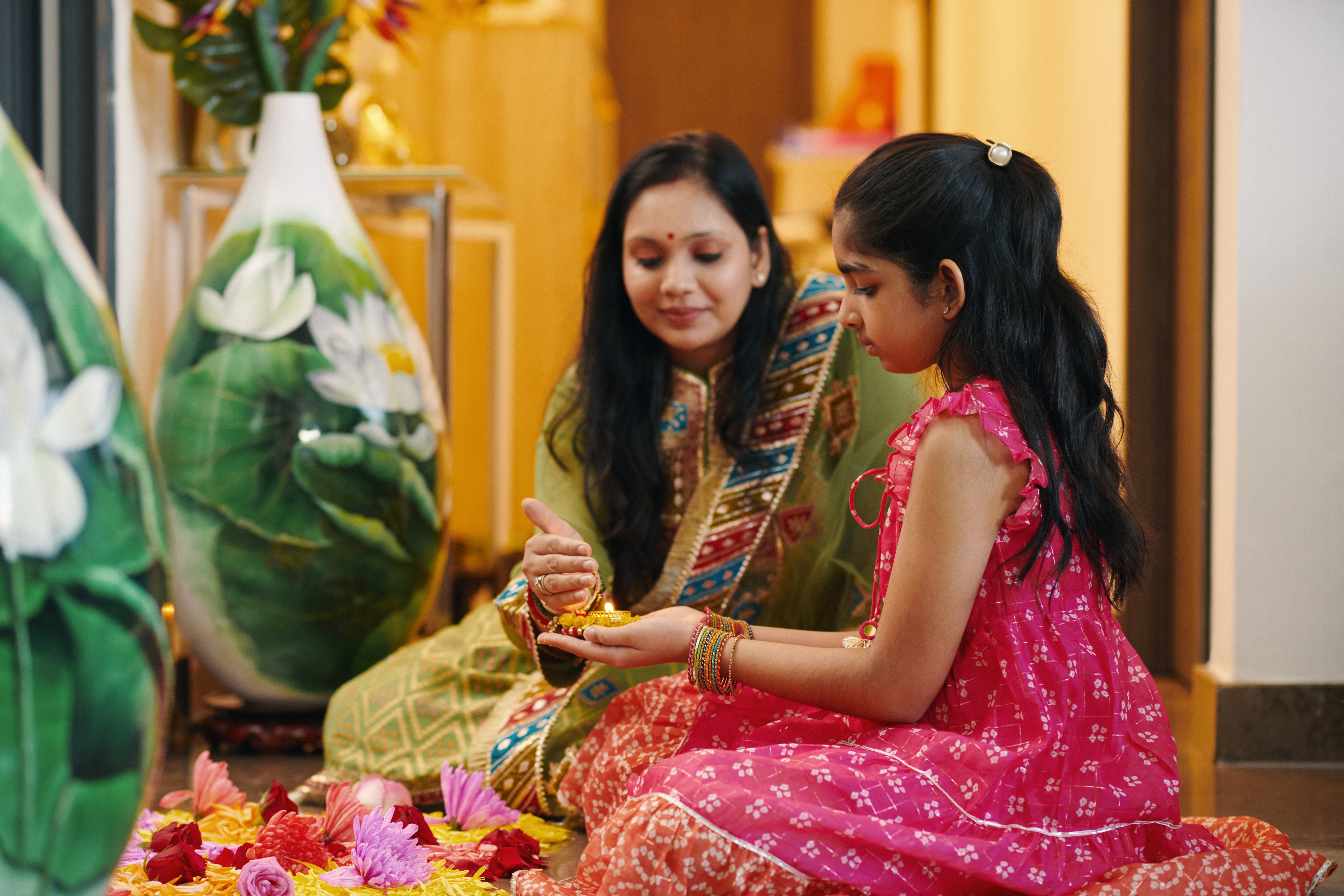 woman and girl holding oil lamp indoors 2026 03 18 14 59 36 utc