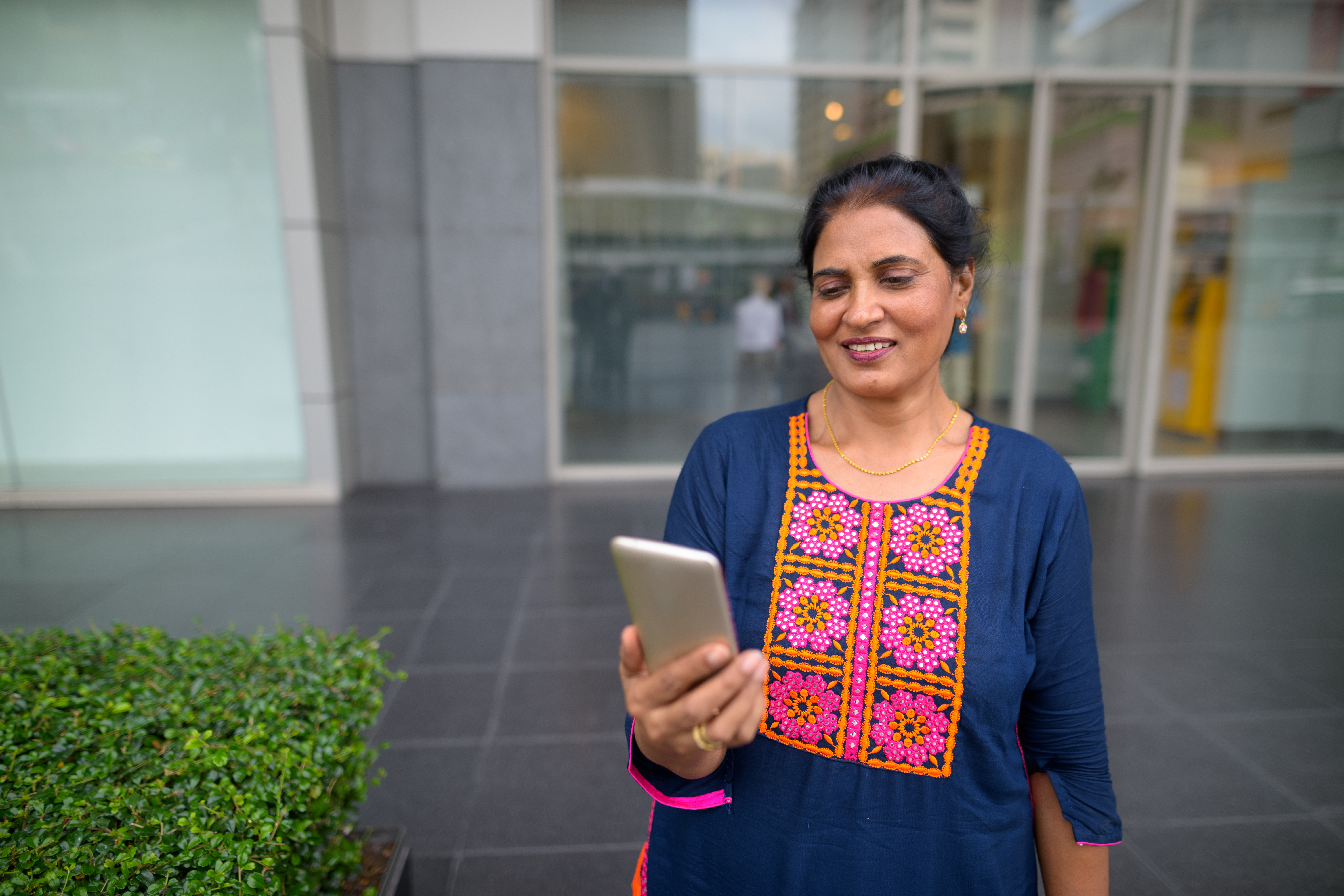 happy indian woman using mobile phone in city 2026 01 07 06 43 26 utc