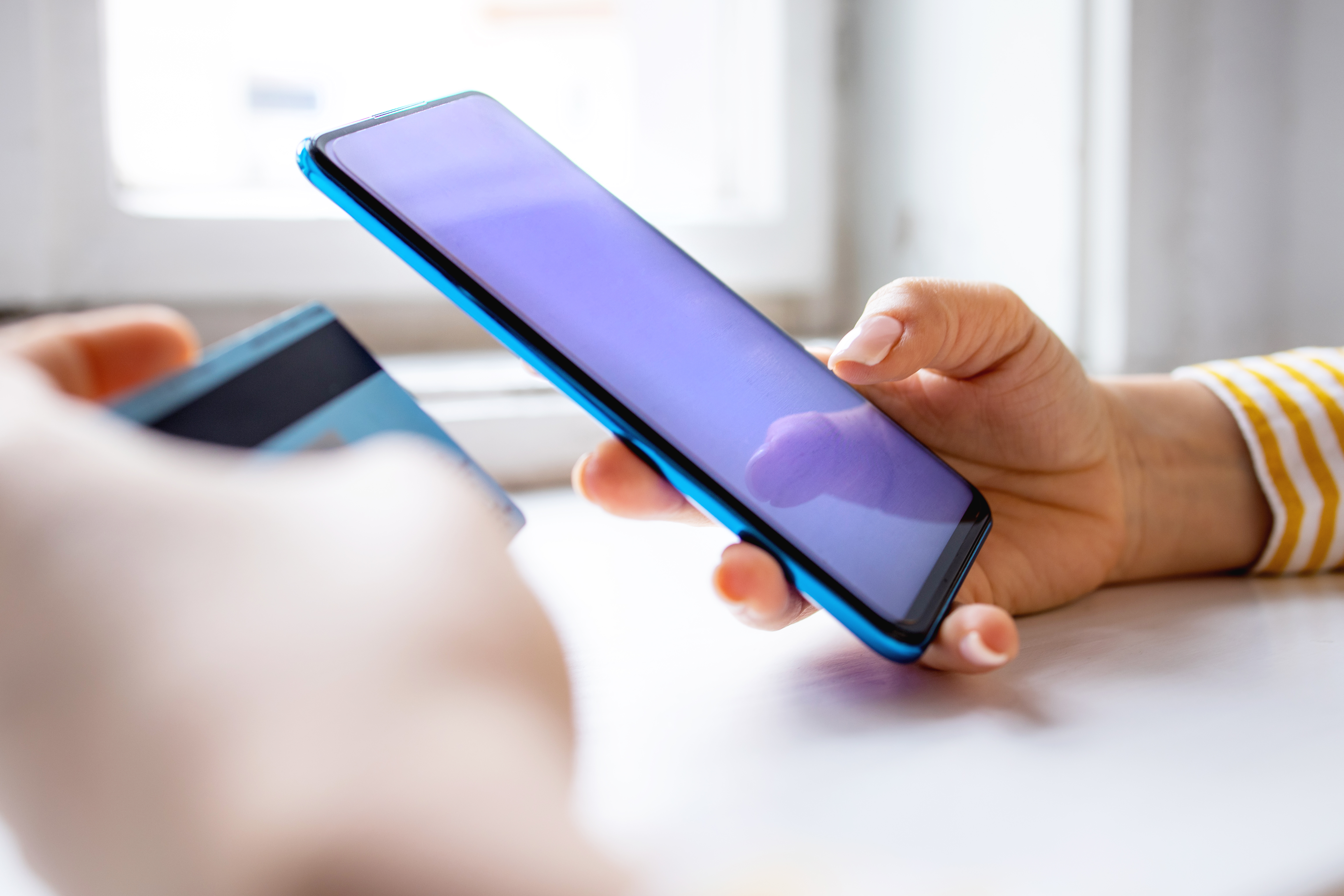 woman holding credit card using mobile phone 2026 03 13 04 13 58 utc