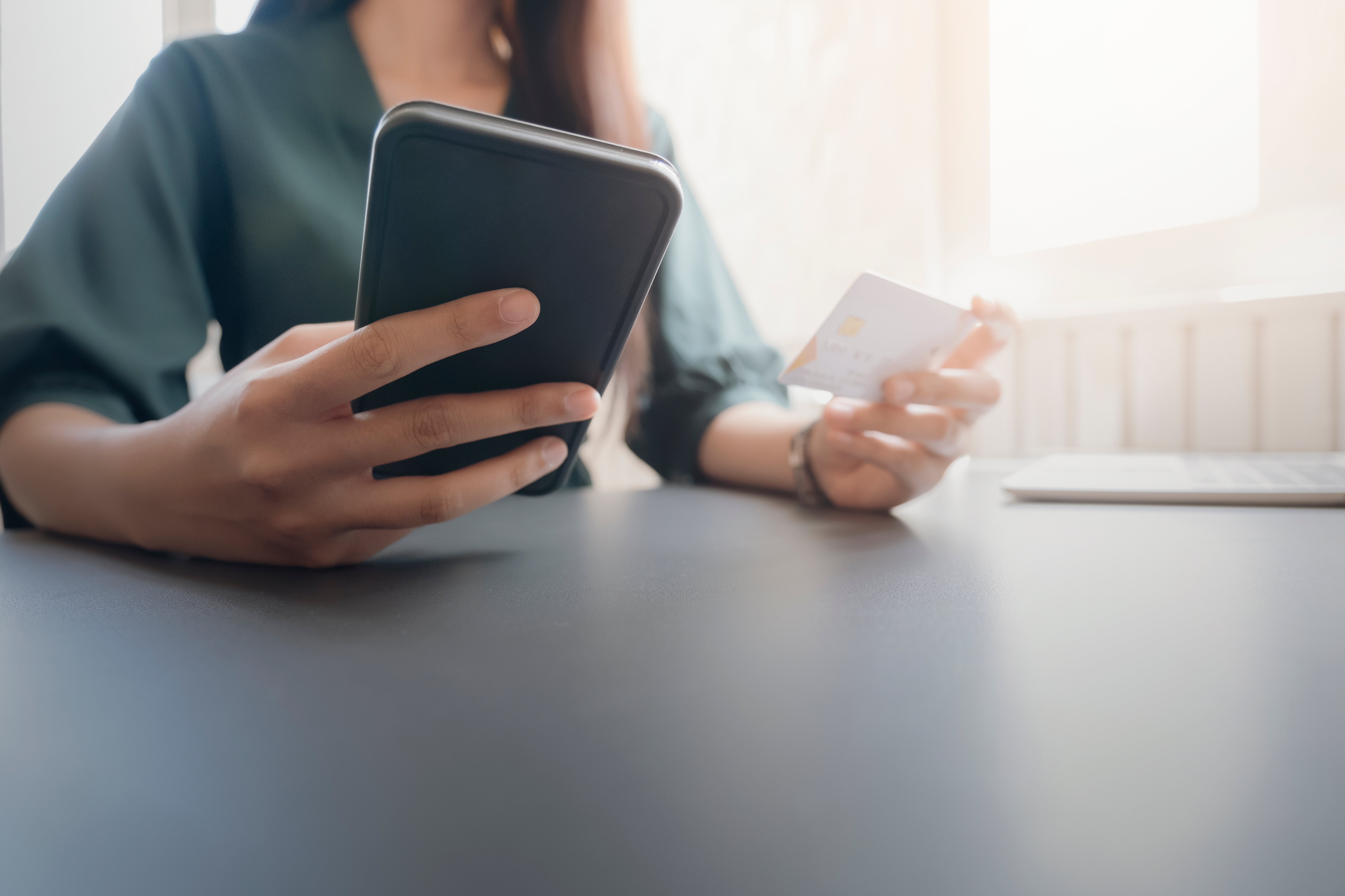 woman using phone and holding credit card 2026 03 24 23 15 28 utc