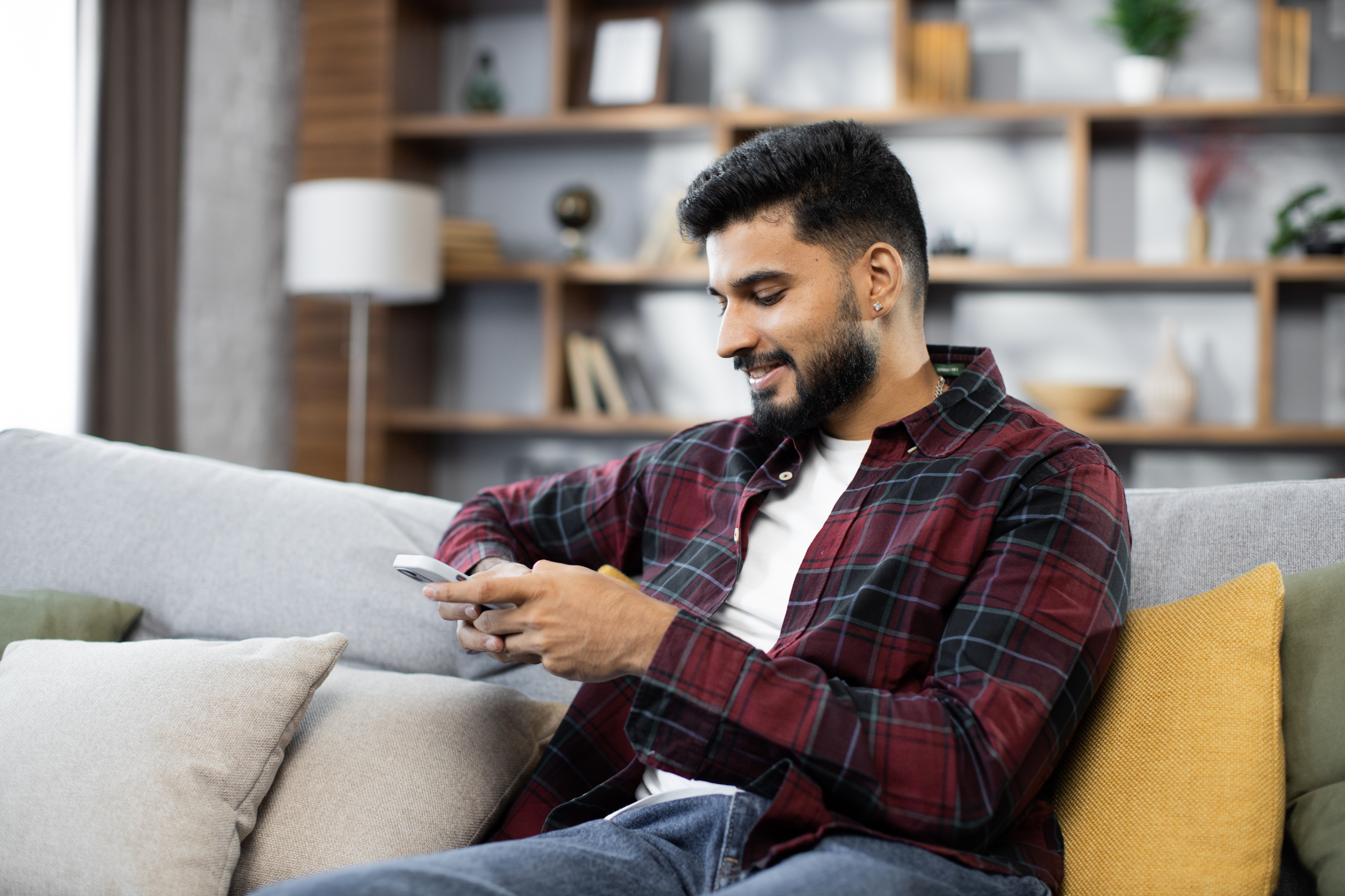 young man relaxing on couch with cellphone 2026 01 07 05 56 44 utc