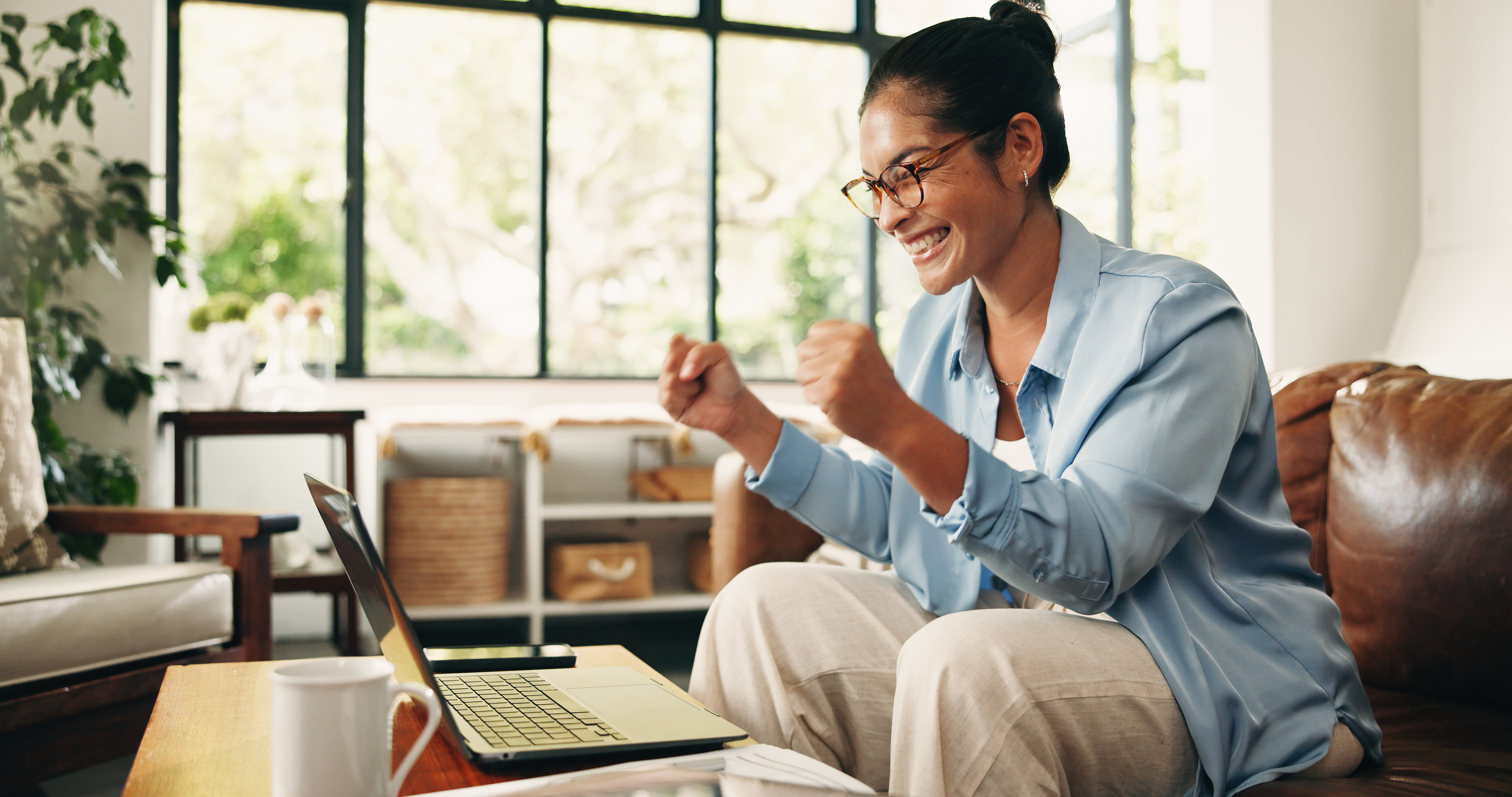 OrbitRemit vs MoneyGram: sending money from Australia compared joyful woman celebrating success while using lapto 2026 06 09 18 25 07 utc