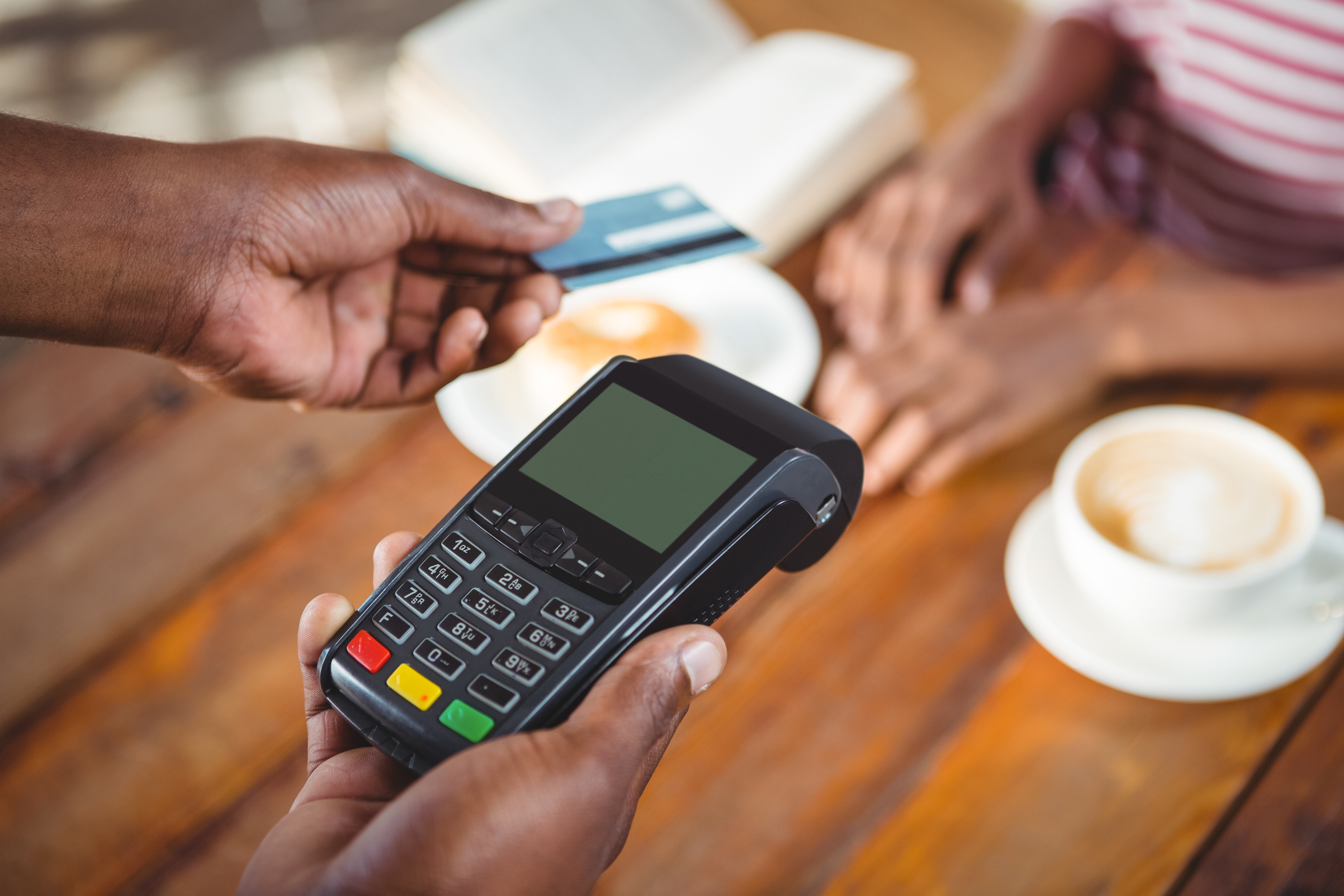 waiter holding credit card machine in cafe 2026 03 26 11 52 05 utc