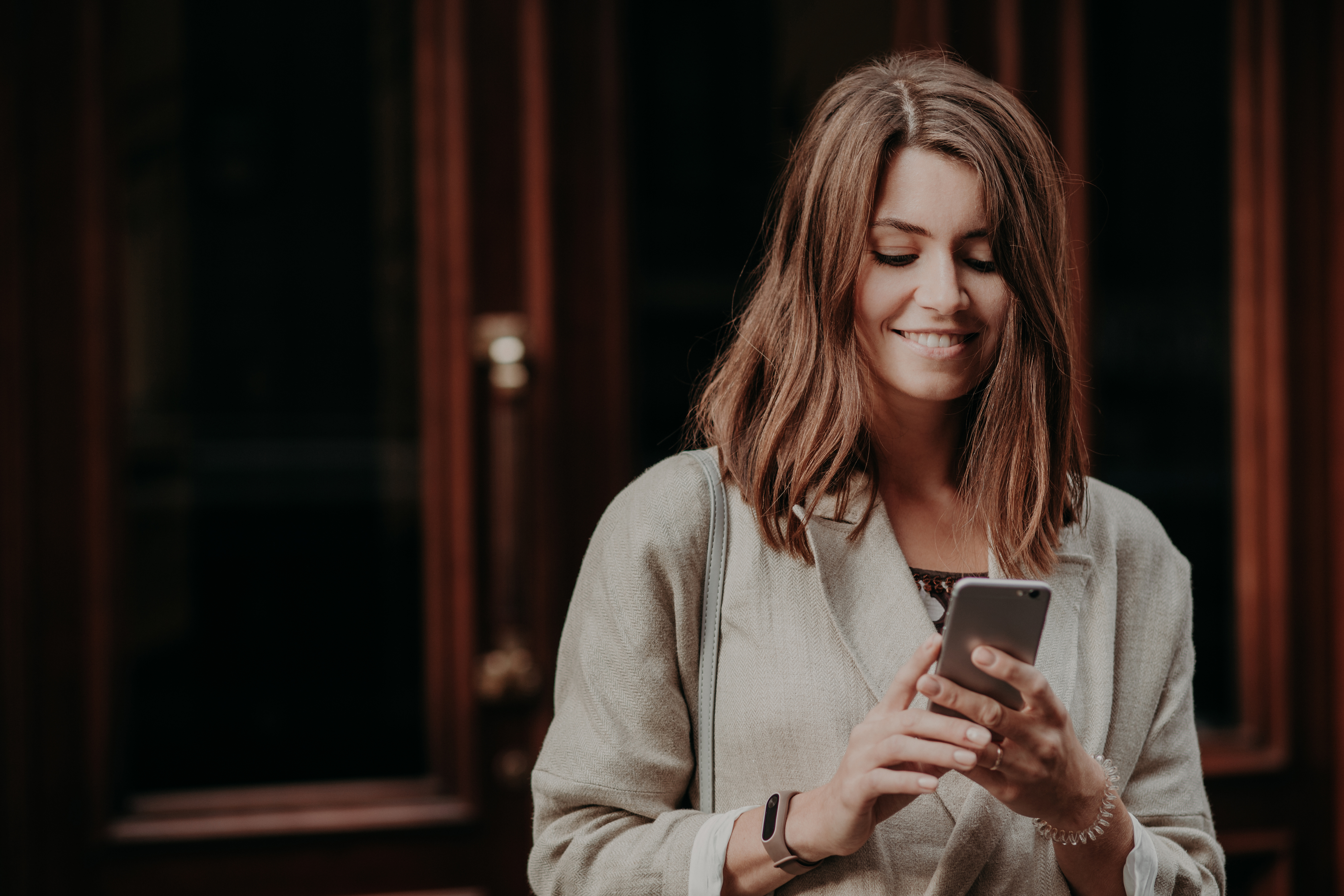 smiling woman using smartphone in urban setting 2026 09 23 21 13 41 utc